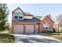 Beautiful two-story home featuring a brick facade, two-car garage, and a welcoming entrance at 8873 Falkirk Ct, Indianapolis, IN 46256