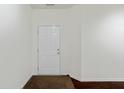 Entryway with a white front door, neutral paint and dark hardwood flooring at 10890 Poppy Hill Dr, Indianapolis, IN 46234