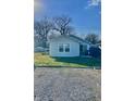 Back exterior view shows a well-kept yard with an outdoor grill and a partial view of a boat at 1133 S Kealing Ave, Indianapolis, IN 46203