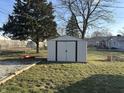 Backyard view features an outdoor shed in a grassy yard, offering practical storage at 1133 S Kealing Ave, Indianapolis, IN 46203