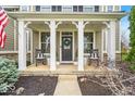 Inviting front porch featuring rocking chairs and charming decor at 11367 Zanardi Ct, Zionsville, IN 46077