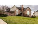Stately brick home with an expansive front lawn, showcasing classic architecture and mature landscaping at 11691 Diamond Pointe Ct, Indianapolis, IN 46236