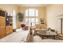 Elegant living room featuring a soaring window, plush seating, and neutral color palette for a serene ambiance at 11691 Diamond Pointe Ct, Indianapolis, IN 46236