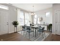 Open dining room boasts modern light fixture, neutral paint, and natural light at 12015 Jeff Ct, Noblesville, IN 46060