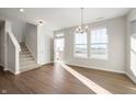 Bright living room with hardwood floors, natural light, and staircase near front door at 12015 Jeff Ct, Noblesville, IN 46060