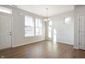 Well-lit living room with hardwood floors, and windows showcasing natural light at 12015 Jeff Ct, Noblesville, IN 46060