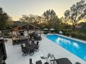 A stunning backyard featuring a large in-ground pool, outdoor kitchen, and ample seating at 1258 Soaring Eagle Dr, Greenwood, IN 46143