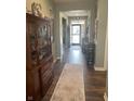 Welcoming hallway featuring hardwood floors, elegant furnishings, and a view of the front door at 1972 Mobley Dr, Westfield, IN 46074