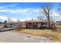 Quaint brick home has a covered carport with an attached garage and small front garden at 230 N School St, Fortville, IN 46040