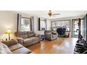 Comfortable living room featuring hardwood floors, neutral paint, and ample natural light at 230 N School St, Fortville, IN 46040
