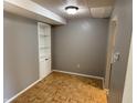 Finished basement area with a built-in shelving unit and parquet flooring at 2826 Country Estates Dr, Indianapolis, IN 46227