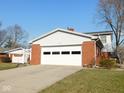 Spacious two car attached garage with brick facade and ample parking space at 3300 Heritage Rd, Columbus, IN 47203