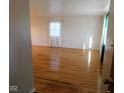 Bright living room with hardwood floors, fresh paint, and large window at 3300 Heritage Rd, Columbus, IN 47203