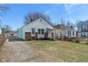 Quaint single-Gathering home featuring white siding and brick accents on a sunny day at 3505 Ralston Ave, Indianapolis, IN 46218