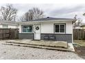 Charming single-story home featuring a well-kept yard and inviting front porch with modern colors at 3867 Asbury St, Indianapolis, IN 46227