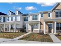 Street view of new townhouses with varied siding, inviting front porches, and tidy landscaping on a sunny day at 3923 Wren Dr, Brownsburg, IN 46112