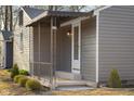 Home featuring a charming covered front porch with decorative railings and a gray exterior at 426 Della Rd, Columbus, IN 47203