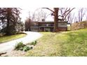 Charming two-story house featuring a curved driveway, a garage, and a partially covered second-story balcony at 490 Valley Dr, Martinsville, IN 46151
