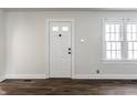 Bright entryway features a white door, neutral walls, updated floors, and natural light at 4929 Young Ave, Indianapolis, IN 46201