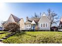 Inviting home with well-kept lawn and landscaping under a clear sky, situated next to neighboring homes at 4929 Young Ave, Indianapolis, IN 46201