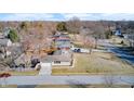An aerial view showcasing the property's layout, garage, surrounding neighborhood, and street access at 5002 Kessler N Blvd, Indianapolis, IN 46228