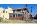 A side angle view of a two story brick home featuring a screened in porch at 518 Central S Ct, Indianapolis, IN 46205