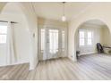 Welcoming foyer with beautiful archways, light-colored walls, and light wood-look flooring at 518 Central S Ct, Indianapolis, IN 46205