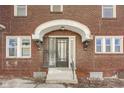 Close up of front door and entryway with a small porch and steps at 518 Central S Ct, Indianapolis, IN 46205