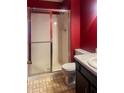 Cozy bathroom with a shower featuring sliding glass doors, a toilet, and a vanity with a sink at 5212 Mason Cir, Indianapolis, IN 46254