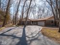 Inviting home with ample parking and a convenient attached garage, surrounded by mature trees at 5309 Michael Ct, Brownsburg, IN 46112