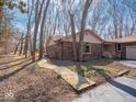 Side view of the house featuring a brick exterior and a wooden pathway to the entrance at 5309 Michael Ct, Brownsburg, IN 46112