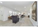 Bright, open-concept living area featuring neutral tones, recessed lighting, and a cozy seating arrangement at 5540 Broadmoor Plz, Indianapolis, IN 46228