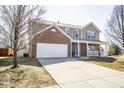 Inviting two-story home showcasing an attached garage and well-maintained front yard at 5897 W River Chase Ln, McCordsville, IN 46055