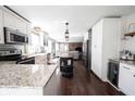 Well-lit kitchen features stainless appliances, granite countertops, a center island, and hardwood floors at 6149 W Country Ln, Anderson, IN 46011