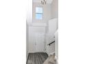 Bright entryway featuring high ceilings, a large window, a white door and staircase with modern gray flooring at 6216 N Woods Edge Ct, McCordsville, IN 46055