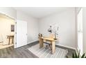 Well-lit office space featuring modern desk and gray floors; an open doorway leads to another room at 6216 N Woods Edge Ct, McCordsville, IN 46055