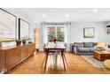 Open concept living space with a dining area, hardwood floors, and stylish furnishings at 629 Williamsburg Ln, Greenwood, IN 46142