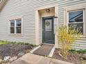 Inviting front entrance with a decorative wreath, wind chimes and well maintained landscaping at 6556 Aintree Ter, Indianapolis, IN 46250