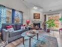 Bright living room featuring a cozy fireplace, stylish seating, and sliding glass doors to the patio at 6556 Aintree Ter, Indianapolis, IN 46250