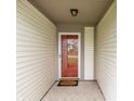 A covered front porch with a red-framed glass door and a 'Welcome' mat at 6704 Granger Ln, Indianapolis, IN 46268