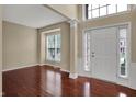 Bright entryway with hardwood floors, neutral walls, and an abundance of natural light at 6806 Powder Dr, Indianapolis, IN 46259