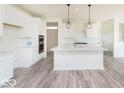 Bright kitchen with white cabinets, stainless appliances, and a spacious island with pendant lights at 6818 Jacone Dr, Brownsburg, IN 46112