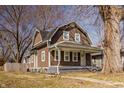Charming brown two-story home with a cozy front porch and well-maintained yard at 706 N Euclid Ave, Indianapolis, IN 46201