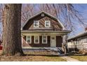 Charming brown two-story home with a cozy front porch and well-maintained yard at 706 N Euclid Ave, Indianapolis, IN 46201