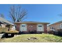 Attractive brick home showcasing a neat front yard and inviting facade under a clear blue sky at 75 S 11Th Ave, Beech Grove, IN 46107