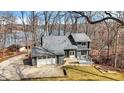 Charming two-story home with stone accents, a two-car garage, and a deck overlooking a tree-filled yard at 7899 S Timber Cliff Ln, Trafalgar, IN 46181