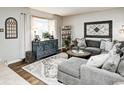 Comfortable living room featuring a sectional sofa, decorative rug, and large window with lots of light at 8010 E County Road 700 N, Brownsburg, IN 46112