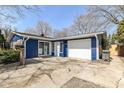 This home features a freshly sealed drive way, an attached garage, and updated exterior paint at 8026 Roy Rd, Indianapolis, IN 46219