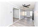 Open living room with modern ceiling fan, neutral gray walls, and durable vinyl flooring at 8026 Roy Rd, Indianapolis, IN 46219