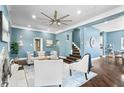 Bright living room featuring a stylish ceiling fan, fireplace, and hardwood floors at 914 Chase St, Anderson, IN 46016